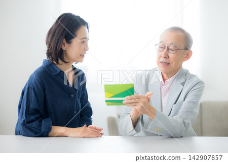 Senior man looking at passbook Senior man looking at passbook 142907857