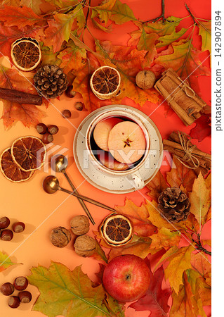 Abstract seasonal composition and still life with autumn greeting card, vibrant autumn banner featuring a cup of tea or mulled wine, maple leaves, pine cones, nuts, cinnamon, star anise, Abstract seasonal composition and still life with autumn greeting card, vibrant autumn banner featuring a cup of tea or mulled wine, maple leaves, pine cones, nuts, cinnamon, star anise, 142907894