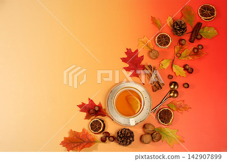 Abstract seasonal composition and still life with autumn greeting card, vibrant autumn banner featuring a cup of tea or mulled wine, maple leaves, pine cones, nuts, cinnamon, star anise, Abstract seasonal composition and still life with autumn greeting card, vibrant autumn banner featuring a cup of tea or mulled wine, maple leaves, pine cones, nuts, cinnamon, star anise, 142907899