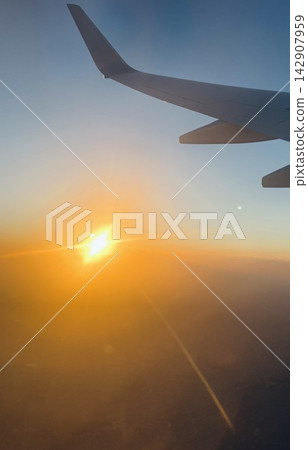 Sunset seen from an airplane window Sunset seen from an airplane window 142907959