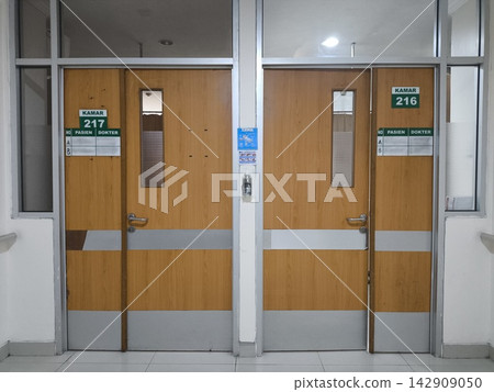 Wooden doors marked 211 and 218 stand side by side Wooden doors marked 211 and 218 stand side by side 142909050