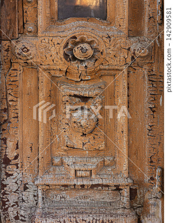 Weathered wooden door showing cracked peeling old paint texture Weathered wooden door showing cracked peeling old paint texture 142909581
