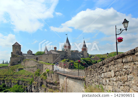 Beautiful view of Kamianets-Podilskyi castle and old bridge on a sunny day. Beautiful view of Kamianets-Podilskyi castle and old bridge on a sunny day. 142909651