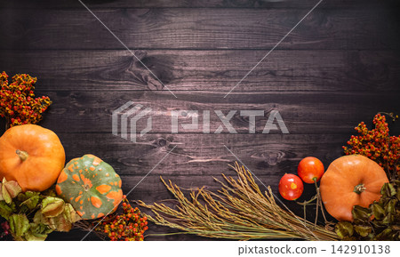 Autumn composition with pumpkins, wheat and berries for Thanksgiving Day on rustic wooden background. Still life background with empty copy space, top view Autumn composition with pumpkins, wheat and berries for Thanksgiving Day on rustic wooden background. Still life background with empty copy space, top view 142910138