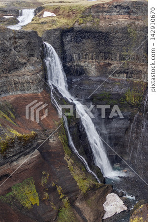 Granni waterfall and upper cascade in a steep layered canyon in Iceland Granni waterfall and upper cascade in a steep layered canyon in Iceland 142910670