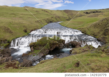 Hestavadsfoss waterfall and mossy rocks on the Skoga River in Iceland in summer Hestavadsfoss waterfall and mossy rocks on the Skoga River in Iceland in summer 142910779