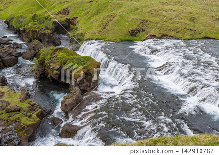 Hestavadsfoss Waterfall and Mossy Rocks on the Skoga River in Iceland in Summer Hestavadsfoss Waterfall and Mossy Rocks on the Skoga River in Iceland in Summer 142910782