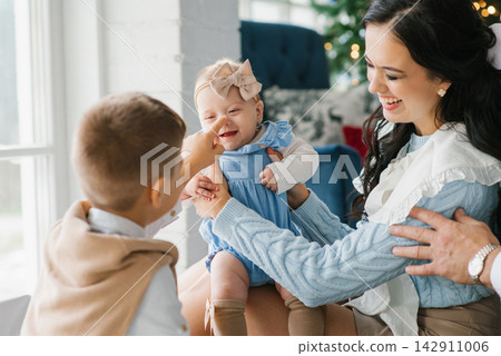 Baby Smiling While Brother Touches Nose At Christmas Baby Smiling While Brother Touches Nose At Christmas 142911006
