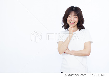 Woman thinking with a smile Woman thinking with a smile 142911600