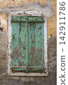 Weathered Green Wooden Shutters with Peeling Paint 142911786