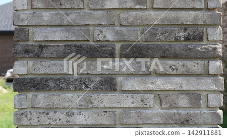 Texture of a brick column made of narrow gray clinker bricks Texture of a brick column made of narrow gray clinker bricks 142911881