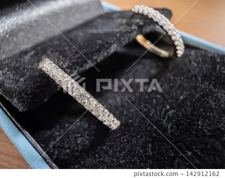 Diamond hoop earrings resting inside a plush black velvet jewelry gift box, capturing a sense of refined elegance and luxury for special occasions like anniversaries or engagement gifts Diamond hoop earrings resting inside a plush black velvet jewelry gift box, capturing a sense of refined elegance and luxury for special occasions like anniversaries or engagement gifts 142912162