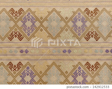 Traditional woven silk fabric with gold geometric diamond pattern Traditional woven silk fabric with gold geometric diamond pattern 142912533