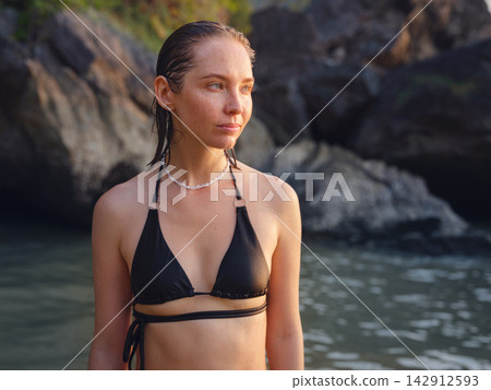 Young woman enjoying serene evening at sea in Krabi, Thailand 142912593