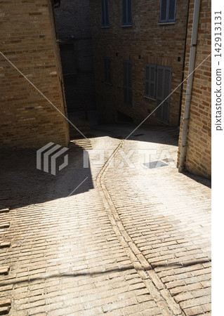 A brick alleyway in the historic center of Urbino, Italy A brick alleyway in the historic center of Urbino, Italy 142913131