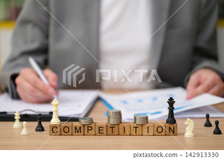Strategic reflections on competition with chess pieces and coins symbolizing analysis and planning Strategic reflections on competition with chess pieces and coins symbolizing analysis and planning 142913330