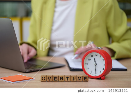 Working late hours as the clock ticks, highlighting the demands of modern professional life Working late hours as the clock ticks, highlighting the demands of modern professional life 142913331