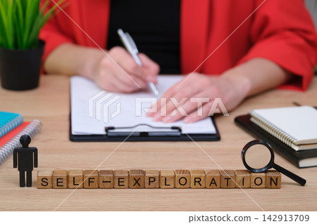 Engaging in self-exploration through writing and reflection during a quiet moment at a desk Engaging in self-exploration through writing and reflection during a quiet moment at a desk 142913709