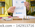 Examining financial growth through charts and strategies in a modern office environment 142913716