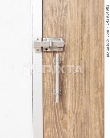 Stainless Steel Slide Latch on Wooden Door Stainless Steel Slide Latch on Wooden Door 142914992