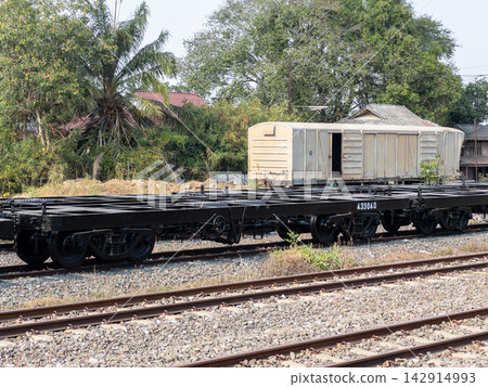 Empty Flatcar Wagon on Railway Tracks Empty Flatcar Wagon on Railway Tracks 142914993