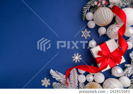 White Christmas Gift with Red Ribbon and Ornaments on Blue White Christmas Gift with Red Ribbon and Ornaments on Blue 142915043