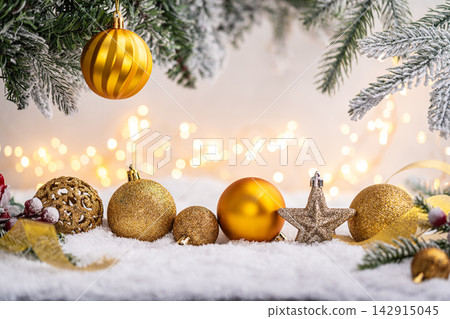 Gold Christmas Ornaments on Snow with Frosted Pine and Berries Gold Christmas Ornaments on Snow with Frosted Pine and Berries 142915045