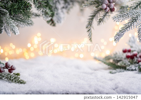Snowy Pine Branches and Berries with Warm Holiday Lights Snowy Pine Branches and Berries with Warm Holiday Lights 142915047