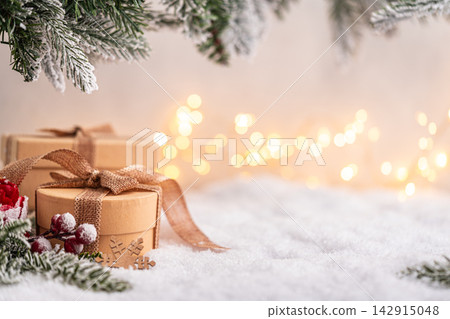 Rustic Gift Boxes on Snow with Frosted Pine and Warm Lights Rustic Gift Boxes on Snow with Frosted Pine and Warm Lights 142915048