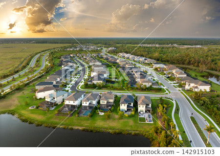American gated community houses in rural US suburbs. View from above of large residential homes in small town in southwest Florida American gated community houses in rural US suburbs. View from above of large residential homes in small town in southwest Florida 142915103