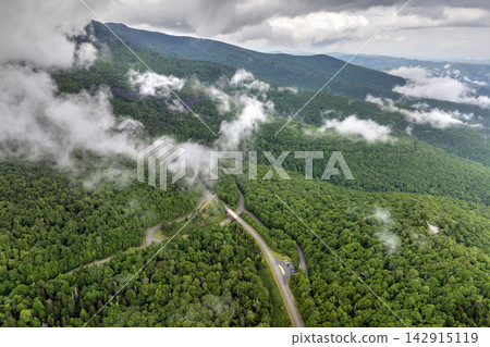 Landscape of Beacon Heights parking lot overlook on Blue Ridge Parkway in summer season. Mountain pass road in North Carolina Appalachian mountains, USA Landscape of Beacon Heights parking lot overlook on Blue Ridge Parkway in summer season. Mountain pass road in North Carolina Appalachian mountains, USA 142915119