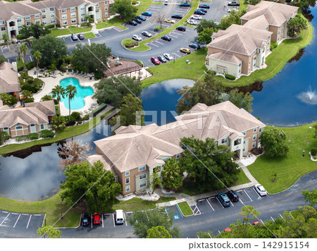 Apartment-style condominiums in Florida suburbs, surrounded by greenery and designed for modern suburban living in the USA Apartment-style condominiums in Florida suburbs, surrounded by greenery and designed for modern suburban living in the USA 142915154