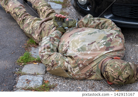 Detained military agent in handcuffs after intelligence operation Detained military agent in handcuffs after intelligence operation 142915167