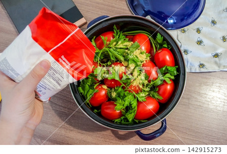 Adding mustard powder to tomatoes for homemade pickling and autumn food preservation Adding mustard powder to tomatoes for homemade pickling and autumn food preservation 142915273