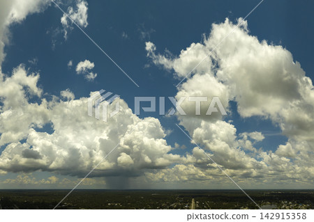 Tropical storm in Florida. Stormy clouds forming during heavy thunderstorm on dark sky. Moving and changing cloudscape weather Tropical storm in Florida. Stormy clouds forming during heavy thunderstorm on dark sky. Moving and changing cloudscape weather 142915358