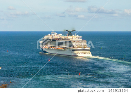 Luxurious cruise ocean liner sailing on Atlantic ocean water departing from Miami, Florida. Luxurious cruise ocean liner sailing on Atlantic ocean water departing from Miami, Florida. 142915364