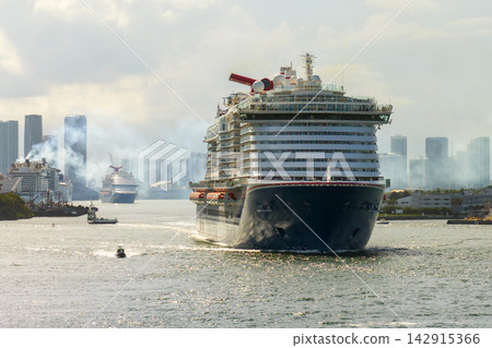 USA travel destination. Miami skyline with ocean cruise liner departing from port. Holiday vacation concept. USA travel destination. Miami skyline with ocean cruise liner departing from port. Holiday vacation concept. 142915366