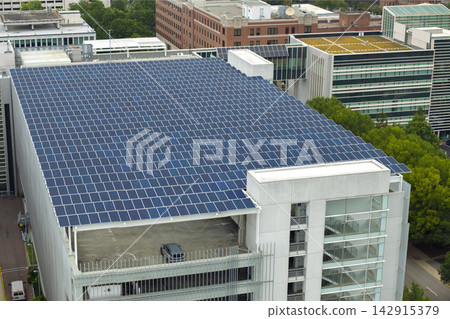 Sustainable power production integrated in urban infrastructure. Photovoltaic solar panels over parking garage for generation of renewable energy. Sustainable power production integrated in urban infrastructure. Photovoltaic solar panels over parking garage for generation of renewable energy. 142915379