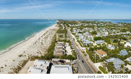 Expensive waterfront houses between green palm trees in Boca Grande, small town on Gasparilla Island in southwest Florida. Premium housing development in the USA Expensive waterfront houses between green palm trees in Boca Grande, small town on Gasparilla Island in southwest Florida. Premium housing development in the USA 142915409