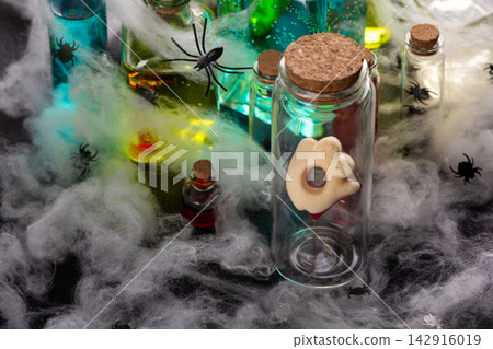 Halloween spooky potion bottles with spiders and cobwebs for decoration Halloween spooky potion bottles with spiders and cobwebs for decoration 142916019