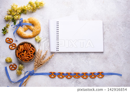 Oktoberfest background with brezel, hops and malt Oktoberfest background with brezel, hops and malt 142916854