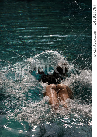 a girl with a beautiful tanned body having fun in the swimming pool of a luxury villa, the girl's butt is visible from under the water, azure water, splashes of water glow in the sun a girl with a beautiful tanned body having fun in the swimming pool of a luxury villa, the girl's butt is visible from under the water, azure water, splashes of water glow in the sun 142917767