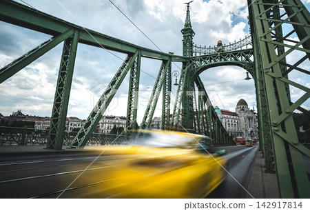 Blurred Rushing Yellow Taxi Moving Fast Along Bridge Blurred Rushing Yellow Taxi Moving Fast Along Bridge 142917814