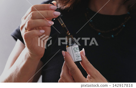 Female Using Hemp Cbd Oil Dropper For Wellness Routine Female Using Hemp Cbd Oil Dropper For Wellness Routine 142917818