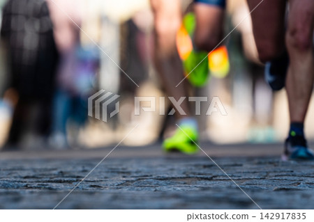 Runners Feet Moving Fast on a Rough Paved Street Runners Feet Moving Fast on a Rough Paved Street 142917835