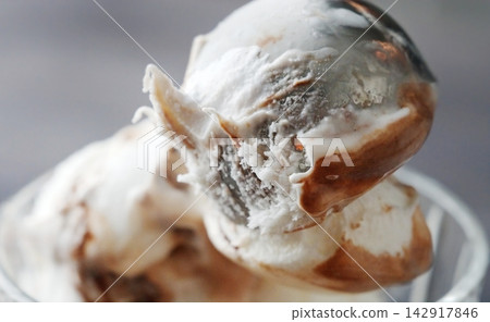 Hands Scooping A Round Portion Of Delicious Ice Cream With Topping Using An Ice Cream Scoop 142917846