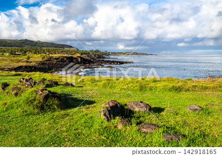 View of the volcanic coastline and green meadows at the Ahu Tahai archaeological site on Easter Island, Rapa Nui, Chile. View of the volcanic coastline and green meadows at the Ahu Tahai archaeological site on Easter Island, Rapa Nui, Chile. 142918165