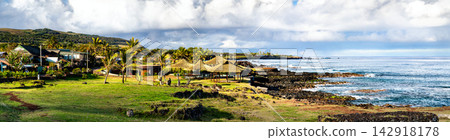 Scenic panoramic view of the rocky shore and thatched huts at Playa Poko Poko in Hanga Roa, Easter Island, Chile Scenic panoramic view of the rocky shore and thatched huts at Playa Poko Poko in Hanga Roa, Easter Island, Chile 142918178