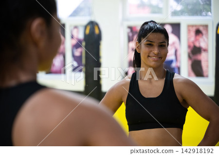 Young Female Athlete Smiling in Gym Portrait After Boxing Training Session With Confidence Young Female Athlete Smiling in Gym Portrait After Boxing Training Session With Confidence 142918192