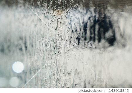 Abstract Water Texture On Glass With Bokeh Blur, Raindrops And Soft Monochrome Reflections 142918245